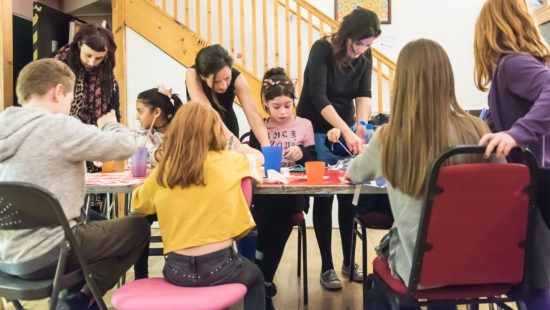 Young carers playing around a table